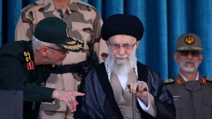 In this picture released by the official website of the office of the Iranian supreme leader, Supreme Leader Ayatollah Ali Khamenei, center, listens to chief of the General Staff of the Armed Forces Gen. Mohammad Hossein Bagheri at a graduation ceremony for a group of armed forces cadets at the police academy in Tehran, Iran, Monday, Oct. 3, 2022. Khamenei responded publicly on Monday to the biggest protests in Iran in years, breaking weeks of silence to condemn what he called “rioting” and accuse the U.S. and Israel of planning the protests. (Office of the Iranian Supreme Leader via AP)