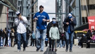 Fans arrive at the Rogers Centre ahead of a baseball game between the Oakland A's and the Blue Jays in Toronto on Sunday, April 17, 2022. The Toronto Blue Jays clinching home field advantage for the American League wild card series will bring a much-needed boost to local businesses this fall. THE CANADIAN PRESS/Christopher Katsarov