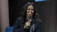 FILE - Former first lady Michelle Obama speaks to the crowd as she presents her anticipated memoir "Becoming" during her book tour stop in Washington, on Nov. 17, 2018. Obama plans a six-city tour this fall in support of her new book, “The Light We Carry: Overcoming in Uncertain Times,” beginning mid-November in Washington. D.C. and ending a month later in Los Angeles. (AP Photo/Jose Luis Magana, File)