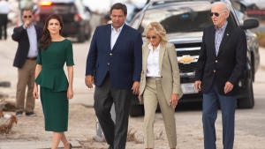 From left, Florida's first lady Casey DeSantis, Gov. Ron DeSantis, first lady Jill Biden and President Joe Biden arrive at Fort Myers Beach, Fla., Wednesday, Oct. 5, 2022, to survey the damage caused by Hurricane Ian. (Saul Young/Knoxville News Sentinel via AP, Pool)