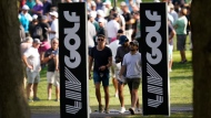 Spectators walk the Rich Harvest Farms golf course during the first round of the LIV Golf Invitational-Chicago tournament Friday, Sept. 16, 2022, in Sugar Grove, Ill. (AP Photo/Charles Rex Arbogast) 