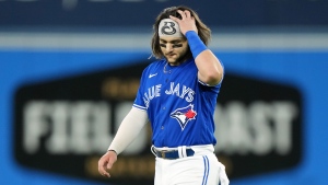 Toronto Blue Jays shortstop Bo Bichette (11) reacts as he walks back to the dugout after grounding out to end the fifth inning of American League wild card MLB postseason baseball action against the Seattle Mariners in Toronto on Friday, October 7, 2022. THE CANADIAN PRESS/Nathan Denette