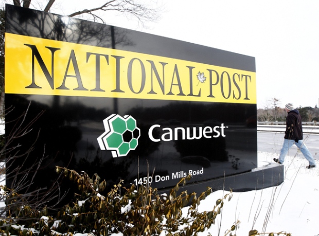 A person walks past the National Post sign, which is one of many newspapers in the Canwest newspaper chain on Friday, Jan. 8, 2010 in Toronto. Canwest has placed all of its newspapers under bankruptcy protection. (Nathan Denette / THE CANADIAN PRESS)  