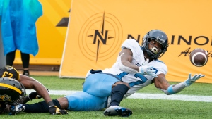Toronto Argonauts wide receiver Markeith Ambles (17) tries to make a pass in the end zone while defended bye Hamilton Tiger Cats defensive back Richard Leonard (23) during second half CFL football game action in Hamilton, Ont. on Monday, September 5, 2022. THE CANADIAN PRESS/Peter Power