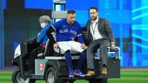 Toronto Blue Jays centre fielder George Springer (4) leaves the field on a cart after being injured against the Seattle Mariners during eighth inning American League wild card MLB postseason baseball action in Toronto on Saturday, October 8, 2022. THE CANADIAN PRESS/Nathan Denette 