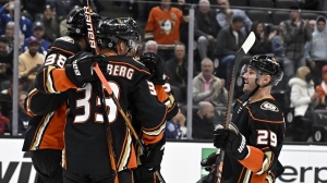 Anaheim Ducks defenseman Dmitry Kulikov, right, joins a celebration after right wing Jakob Silfverberg (33) scored against the Toronto Maple Leafs during the first period of an NHL hockey game in Anaheim, Calif., Sunday, Oct. 30, 2022. (AP Photo/Alex Gallardo)