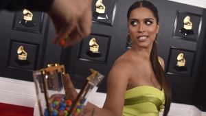 Lilly Singh gives out candy from her purse as she arrives at the 62nd annual Grammy Awards at the Staples Center on Sunday, Jan. 26, 2020, in Los Angeles. Singh has been tapped as host and executive producer of the inaugural season of CTV’s primetime quiz show “BATTLE OF THE GENERATIONS.” THE CANADIAN PRESS/AP-Jordan Strauss/Invision/AP
