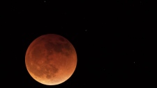 The moon is shown during a full lunar eclipse