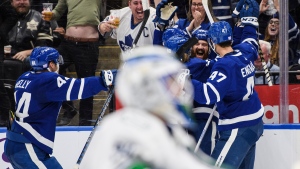 Toronto Maple Leafs defenceman Jordie Benn (18) celebrates with team mates after scoring during second period NHL hockey action against the Vancouver Canucks, in Toronto on Saturday, Nov. 12, 2022. THE CANADIAN PRESS/Christopher Katsarov