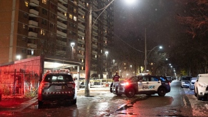 Police cars block the entrance to a high-rise building on Dunn Ave after 4 people were shot, in Toronto, Tuesday, Nov. 15, 2022. Police say one person is dead and three others have been injured after shots rang out in an apartment building on Dunn Ave near Queen St West. THE CANADIAN PRESS/Arlyn McAdorey