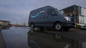 FILE - An Amazon Prime truck drives in Pacifica, Calif., on Dec. 15, 2020. Amazon has begun mass layoffs in its corporate ranks, becoming the latest tech company to trim its workforce amid rising fears about the wider economic environment. (AP Photo/Jeff Chiu, File)