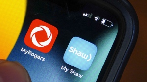 Rogers and Shaw applications are pictured on a cellphone in Ottawa, Monday, May 9, 2022. THE CANADIAN PRESS/Sean Kilpatrick