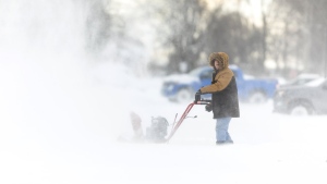 A man uses a snowblower in Fort Erie, Ont., during an early winter storm that delivered high winds and large amounts of snow across southern Ontario and western New York, Saturday, Nov. 19, 2022. THE CANADIAN PRESS/Nick Iwanyshyn