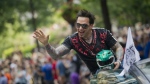 FILE - Jason David Frank waves to the crowd as he makes his way down Peachtree Street in the annual DragonCon parade through downtown Atlanta, on Aug. 31, 2013. Frank, who played the Green Power Ranger Tommy Oliver on the 1990s children's series “Mighty Morphin Power Rangers," has died, according to a statement Sunday, Nov. 20, 2022, from his manager, Justine Hunt. He was 49. (Jonathan Phillips/Atlanta Journal-Constitution via AP, File)