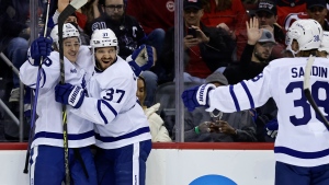 Toronto Maple Leafs right wing Pontus Holmberg, left, is congratulated by Timothy Liljegren (37) and Rasmus Sandin (38) after scoring a goal against the New Jersey Devils during the first period of an NHL hockey game Wednesday, Nov. 23, 2022, in Newark, N.J. (AP Photo/Adam Hunger)
