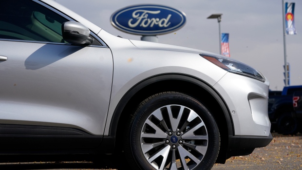 In this Sunday, Oct. 11, 2020 file photo, A row of 2020 Ford Escape sports-utility vehicles sits at a Ford dealership in Denver. (AP Photo/David Zalubowski, File) 
