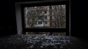 Broken glass lay on the floor of a building damaged during a Russian strike in Kherson, southern Ukraine, Friday, Nov. 25, 2022. (AP Photo/Bernat Armangue)