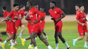 Canada star Alphonso Davies, second right, warms up with teammates during practice at the World Cup in Doha, Qatar, Friday, Nov. 25, 2022. THE CANADIAN PRESS/Nathan Denette 