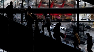 Shoppers walk up and down the stairs in a Nike store on Black Friday, Nov. 25, 2022, in New York. (AP Photo/Julia Nikhinson)
