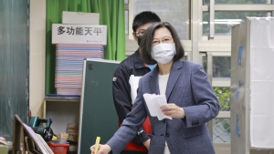 Taiwan President Tsai Ing-wen casts her ballots at a polling station in New Taipei City, Taiwan, Saturday, Nov. 26, 2022. (Chang Hao-an/Pool Photo via AP)