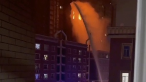 In this image taken from video, firefighters spray water on a fire at a residential building in Urumqi in western China's Xinjiang Uyghur Autonomous Region, Thursday, Nov. 24, 2022. (AP Photo)