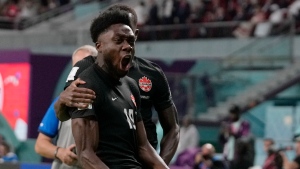 Canada's Alphonso Davies celebrates after scoring his side's opening goal during the World Cup group F soccer match between Croatia and Canada, at the Khalifa International Stadium in Doha, Qatar, Sunday, Nov. 27, 2022. (AP Photo/Thanassis Stavrakis)