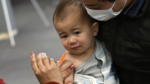 Taika Loo, 16 months, receives a COVID-19 vaccine