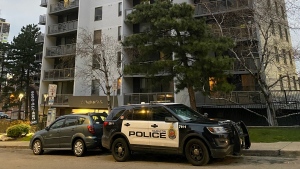 Police are pictured outside a Hamilton highrise, where a woman was found without vital signs following a fire Monday, November 28, 2022. (Mike Nguyen /CP24)