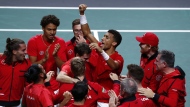 Canada's Felix Auger Aliassime, center, celebrates with teammate after defeating Australia's Alex de Minaur during the final Davis Cup tennis match between Australia and Canada in Malaga, Spain, Sunday, Nov. 27, 2022. THE CANADIAN PRESS/AP-Joan Monfort