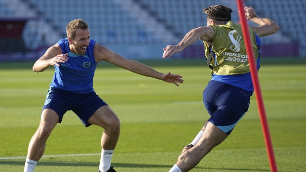 England's Harry Kane, left, and England's Jack Grealish take part in drills at Al Wakrah Sports Complex on the eve of the group B World Cup soccer match between England and Wales, in Al Wakarah, Qatar, Monday, Nov. 28, 2022. (AP Photo/Abbie Parr)