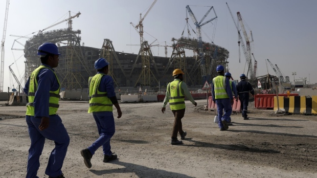Workers walk to the Lusail Stadium Qatar