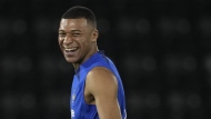 France's Kylian Mbappe, jokes with teammates during a training session at the Jassim Bin Hamad stadium in Doha, Qatar, Monday, Nov. 28, 2022. France will play in the World Cup against Tunisia on Nov. 30. (AP Photo/Christophe Ena)