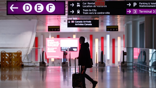 Travellers make their way through Pearson International Airport in Toronto Monday, Nov. 14, 2022. THE CANADIAN PRESS/Cole Burston 