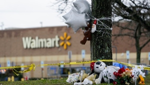 A makeshift memorial is seen in the parking lot of the Walmart Supercenter in Chesapeake, Va., Sunday, Nov. 27, 2022. Six people were killed when a manager opened fire at the store with a handgun on Tuesday. (AP Photo/Carolyn Kaster)