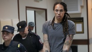 WNBA star and two-time Olympic gold medalist Brittney Griner is escorted from a courtroom after a hearing in Khimki just outside Moscow, Russia, on Aug. 4, 2022. (AP Photo/Alexander Zemlianichenko, File)
