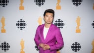 Simu Liu poses for a photograph at the media wall after hosting the 2022 Juno Awards Broadcast at the Budweiser Stage in Toronto, Sunday, May 15, 2022. Organizers at the Canadian Academy of Recording Arts and Sciences announced Wednesday that actor/author/social media phenom Simu Liu will take the reins of Canada's biggest night in music for the second year in a row. THE CANADIAN PRESS/ Tijana Martin
