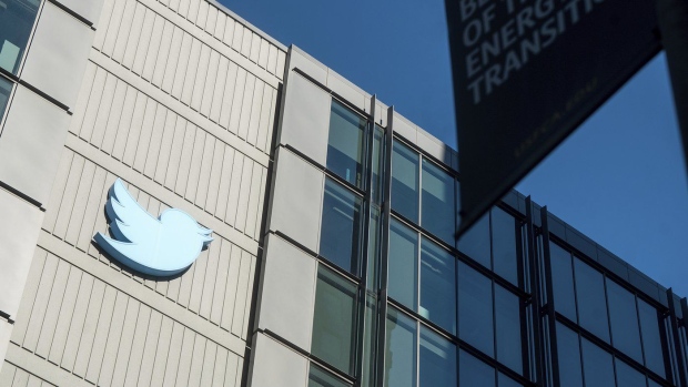 FILE - A Twitter logo hangs outside the company's San Francisco offices on Nov. 1, 2022. A top European Union official warned Elon Musk on Wednesday Nov. 30, 2022 that Twitter needs to beef up measures to protect users from hate speech, misinformation and other harmful content to avoid violating new rules that threaten tech giants with big fines or even a ban in the 27-nation bloc. (AP Photo/Noah Berger, File)