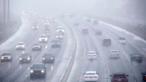 FILE - Cars drive along Toronto's Lakeshore Drive as visibility diminishes through falling hail, snow, and rain in Toronto, Ontario on Saturday, April 14, 2018. THE CANADIAN PRESS/Cole Burston 