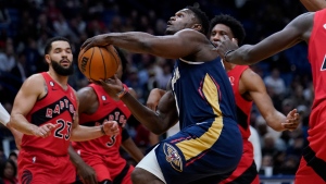 New Orleans Pelicans forward Zion Williamson (1) drives to the basket between Toronto Raptors guard Fred VanVleet (23) and forward Pascal Siakam (43) in the first half of an NBA basketball game in New Orleans, Wednesday, Nov. 30, 2022. (AP Photo/Gerald Herbert)