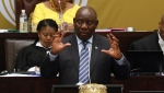 South African President Cyril Ramaphosa responds to questions in Parliament Cape Town, South Africa, Thursday, Sept. 29, 2022 where he denied allegations of money laundering while being questioned over a scandal that threatens his position and the direction of Africa's most developed economy. Ramaphosa is facing serious calls to step down after a parliamentary probe found he may have breached the country's anti-corruption laws related to the theft of millions of dollars at his Phala Phala game farm. (AP Photo/Nardus Engelbrecht/File)
