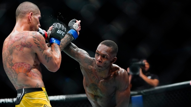 Nigeria's Israel Adesanya, right, punches Brazil's Alex Pereira during the fourth round of a middleweight bout at the UFC 281 mixed martial arts event early Sunday, Nov. 13, 2022, in New York. Pereira stopped Adesanya in the fifth round. (AP Photo/Frank Franklin II)