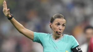 Referee Stephanie Frappart holds her arm up during the World Cup group E soccer match between Costa Rica and Germany at the Al Bayt Stadium in Al Khor, Qatar, Thursday, Dec.1, 2022. (AP Photo/Moises Castillo)