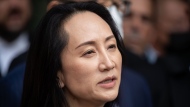 Meng Wanzhou, chief financial officer of Huawei, reads a statement outside B.C. Supreme Court, in Vancouver, B.C., Friday, Sept. 24, 2021. THE CANADIAN PRESS/Darryl Dyck