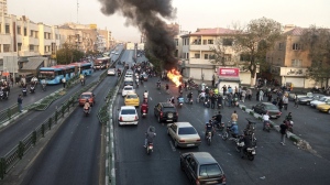 A motorcycle of Basij, Iranian paramilitary militia, is set on fire during a protest after a 22-year-old woman Mahsa Amini's death when she was detained by the morality police, in Tehran, Monday, Oct. 10, 2022 in this photo taken by an individual not employed by the Associated Press and obtained by the AP outside Iran. Canada is sanctioning more Iranian officials, including a senior military official spotted earlier this year at a Toronto-area gym. THE CANADIAN PRESS/AP-Middle East Images