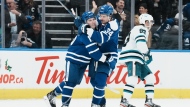 Toronto Maple Leafs' Mitchell Marner (left) celebrates with Auston Matthews after scoring an empty net goal against the San Jose Sharks during third period NHL hockey action in Toronto, on November 30, 2022. THE CANADIAN PRESS/Chris Young