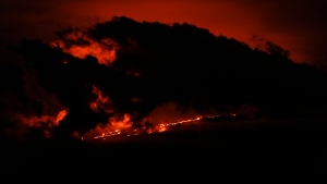 Lava flows from the Mauna Loa volcano Friday, Dec. 2, 2022, near Hilo, Hawaii. (AP Photo/Gregory Bull)