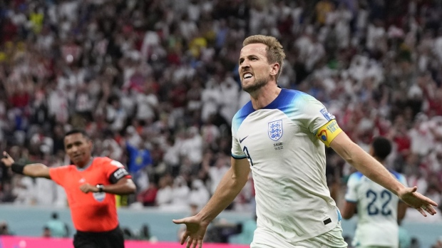 England's Harry Kane celebrates scoring his side's second goal during the World Cup round of 16 soccer match between England and Senegal, at the Al Bayt Stadium in Al Khor, Qatar, Sunday, Dec. 4, 2022. (AP Photo/Frank Augstein)