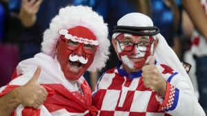 Croatia and Canada fans cheer ahead of the World Cup group F soccer match between Croatia and Canada, at the Khalifa International Stadium in Doha, Qatar, Sunday, Nov. 27, 2022. At a World Cup that has become a political lightning rod, it comes as no surprise that soccer fans’ sartorial style has sparked controversy. At the first World Cup in the Middle East, fans from around the world have refashioned traditional Gulf Arab headdresses and thobes. (AP Photo/Darko Vojinovic, File)