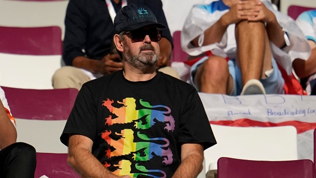An England fan wearing a rainbow shirt