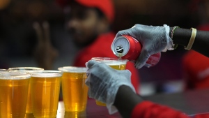 FILE - Staff member pours a beer at a fan zone ahead of the FIFA World Cup, in Doha, Qatar Saturday, Nov. 19, 2022. The last-minute decision to ban the sale of beer at World Cup stadiums in Qatar is the latest example of some the tensions that have played out ahead of the tournament. Qatari officials have for long said they were eager to welcome everybody but that visitors should also respect their culture and traditions. (AP Photo/Petr Josek)